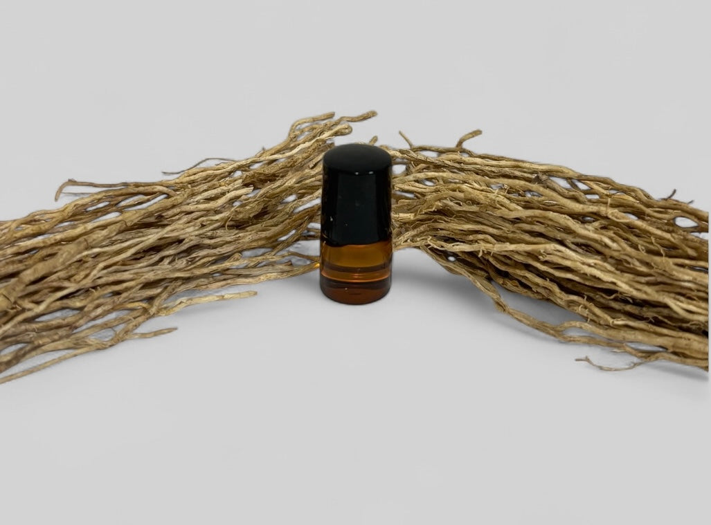 Small brown bottle with black cap on a white background